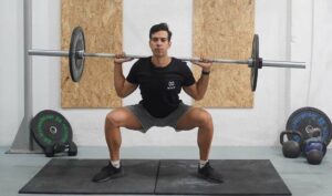 man sumo squat barbell